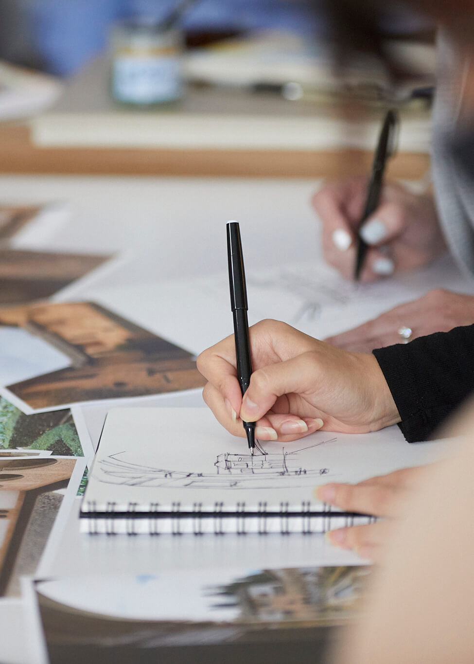 Detail of persons hands while they sketch 